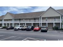 Apartment building featuring multi-story units and a well-maintained parking lot for resident and guest convenience at 134 Butkus Dr. # 7, Myrtle Beach, SC 29588