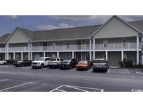 Exterior full view of the apartment building and parking with a clear sky at 134 Butkus Dr. # 7, Myrtle Beach, SC 29588