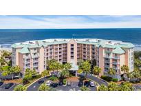Beautiful aerial view of the condo building with ocean views, green roof and a roundabout entrance at 145 South Dunes Dr. # 308, Pawleys Island, SC 29585
