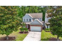 Charming two-story home with gray siding, brick accents, manicured landscaping, and a two-car garage at 1535 Harlow Ct., Myrtle Beach, SC 29579