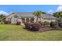 Charming single story brick home boasting a well-manicured lawn and mature landscaping at 2060 Woodburn Dr., Myrtle Beach, SC 29579