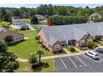 Beautiful condo featuring a well manicured lawn, ample parking, and community amenities like a pool and tennis court at 4648 Lightkeepers Way # 39A, Little River, SC 29566