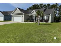 Well maintained one-story home featuring a manicured front yard with fresh green grass and landscaping at 541 Irees Way, Longs, SC 29568