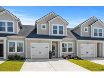 Charming townhome featuring a one-car garage, well-maintained lawn, and neutral color palette at 563 Sea Sparrow St. # 563, Myrtle Beach, SC 29588