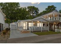 Charming coastal home featuring a screened porch, picket fence, and detached garage at 6001 - 5442 S Kings Hwy., Myrtle Beach, SC 29575
