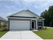 Charming single-story home with gray siding, a two-car garage, and a well-manicured lawn at 602 Muster Field Ct., Conway, SC 29526