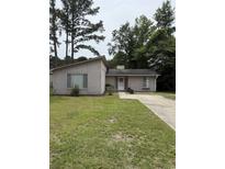 Charming single-story home with a well-maintained lawn and a long driveway at 615 Todd Blvd., Conway, SC 29526