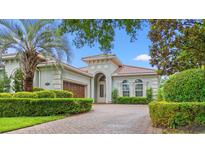 Charming home featuring an elegant facade, arched entryway, manicured hedges and a neatly paved driveway at 7545 Ventura Ct., Myrtle Beach, SC 29572