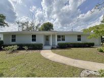 Charming single-story home with a brick facade, well-manicured lawn, and a inviting walkway at 7611 Coteswood Dr., Myrtle Beach, SC 29572