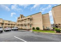Inviting exterior view showcases complex's balconies, stairs, parking and lush landscaping at 9661 Shore Dr. # B7-29, Myrtle Beach, SC 29572
