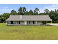 Charming ranch-style home with a long covered porch and spacious front yard at 971A Mcnabb Rd., Loris, SC 29569