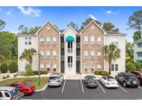 Condo complex with stone accents, palm trees, and well-maintained landscaping creates an inviting, coastal feel at 9776 Leyland Dr. # 2, Myrtle Beach, SC 29572