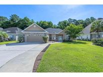 Charming single-story home with a well-manicured lawn and attached two-car garage at 110 Ashworth Dr., Little River, SC 29566