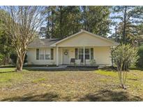 Charming single-story home with a manicured lawn and welcoming front porch at 1300 Ragin St., Myrtle Beach, SC 29577