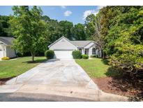 Charming single-story home boasts a well-manicured lawn and a long, inviting driveway at 161 Patriot Ln., Pawleys Island, SC 29585