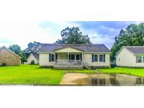 Charming single-story home with a cozy front porch and well-maintained lawn at 2432 Farmwood Circle, Conway, SC 29527