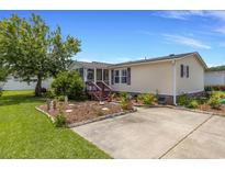 Well-maintained home features a beautiful landscaped yard and a welcoming front entrance, perfect for curb appeal at 259 Iroquis Trail, Longs, SC 29568