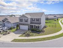 Beautiful gray two-story home featuring a spacious front yard and an attached two-car garage at 2989 Skylar Dr., Myrtle Beach, SC 29577