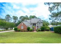 Charming two-story home with a brick facade and lush landscaping at 302 Sunnehanna Dr., Myrtle Beach, SC 29588