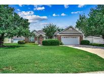 Charming single-story home boasts a well-manicured lawn and mature trees at 303 Ayrie Ct., Conway, SC 29527
