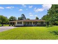 Charming single-story home with a spacious front yard and inviting front porch at 308 Old Stage Rd., Mullins, SC 29574