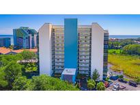 Stunning exterior view of a beachfront condo building with direct access to the beach and community parking at 311 69Th Ave. N # 302, Myrtle Beach, SC 29572