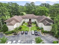 Overhead view of a tan apartment complex featuring well-manicured grounds and convenient parking at 405 Pipers Ln. # 405, Myrtle Beach, SC 29575