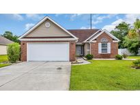 Charming single-Gathering home featuring a brick facade, attached garage, and well-manicured lawn at 405 Vintage Circle, Myrtle Beach, SC 29579