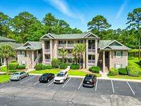 Beautiful condo complex featuring multiple stories, manicured landscaping, and ample parking at 45 Pinehurst Ln. # 2C, Pawleys Island, SC 29585