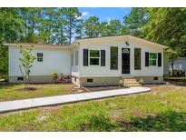 Charming single-story home with white siding, black shutters, and a well-manicured front yard at 5074 Cowart Ct., Murrells Inlet, SC 29576