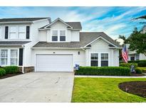 Charming two-story home with a well-manicured lawn, attached garage and beautiful blue skies above at 6095 Catalina Dr. # 714, North Myrtle Beach, SC 29582