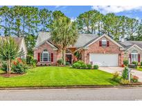 Charming brick home with a manicured lawn, mature trees, and an attached two-car garage at 6434 Longwood Dr., Murrells Inlet, SC 29576