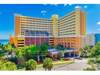 Beautiful multi-story hotel with manicured landscaping, vibrant flowers, and lush green trees at 6900 N Ocean Blvd. # 840, Myrtle Beach, SC 29572