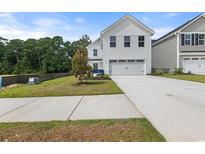 Charming two-story home with a two-car garage and well-maintained landscaping in a desirable neighborhood at 1096 Oak Meadow Dr., Conway, SC 29526
