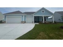 Charming one-story home with a two-car garage, and light blue siding and a well manicured lawn at 1117 Oxeye St., North Myrtle Beach, SC 29582