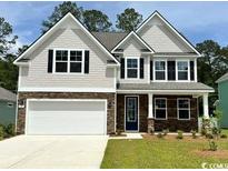 Charming two-story home with stone accents, gray siding, well-maintained lawn, and two-car garage at 135 Stride Ct., Myrtle Beach, SC 29588