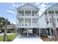 Charming raised beach house with dual balconies and ample covered parking and convenient beach access at 135B Sunset Dr., Murrells Inlet, SC 29576