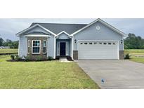 Charming single-story home with blue siding, stone accents, and a well-maintained lawn at 181 Norris Ln, Loris, SC 29569