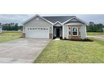 Charming single-Gathering home showcasing a two-car garage, brick accents, and a well-manicured lawn at 185 Norris Ln, Loris, SC 29569