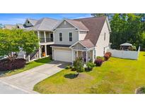 Charming two-story home featuring a well-maintained yard and an attached two-car garage at 309 Foxpath Loop, Myrtle Beach, SC 29588