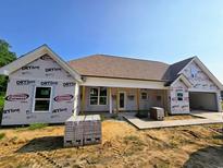 New home showing exterior with tan brick and white trim under a bright blue sky at 3619 Allentown Dr., Conway, SC 29526