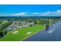 Beautiful aerial view of golf course community, waterway access, and lush green landscape under a bright blue sky at 4018 Fairway Lakes Dr. # 4018, Myrtle Beach, SC 29577
