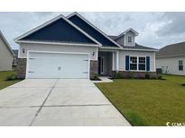 Charming single-story home with a two-car garage, well-manicured lawn, and welcoming curb appeal at 434 Lifestyle Court, Surfside Beach, SC 29575