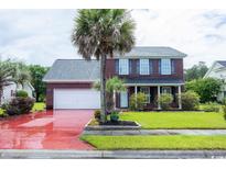 Charming two-story brick home with a well-manicured lawn and mature palm trees at 5096 Capulet Circle, Myrtle Beach, SC 29588