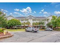 Spacious condo building featuring multiple levels with balconies and ample parking at 5825 Catalina Dr. # 125, North Myrtle Beach, SC 29582