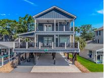 Beautiful, elevated beach house with double decks, outdoor entertainment space, and ample parking at 6001- Q10 S Kings Hwy., Myrtle Beach, SC 29575