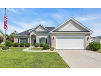 Charming single-story home with well-manicured lawn and attached two-car garage at 605 Fieldwoods Dr., Conway, SC 29526