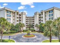 Beautiful condo complex with meticulously landscaped entrance and mature palm trees at 741 Retreat Beach Circle # B-1-A, Pawleys Island, SC 29585