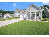 Charming home featuring a well-manicured lawn, inviting porch, and attached garage, perfect for modern living at 775 Harrison Mill St., Myrtle Beach, SC 29579
