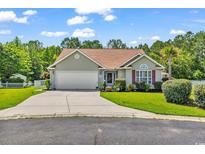 Charming single-story home with a well-manicured lawn, a two-car garage, and mature trees at 824 Dunoway Ct., Myrtle Beach, SC 29579